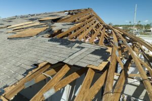 Damaged house roof with missing shingles 