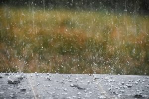 hail splashing in rain water during a hailstorm 