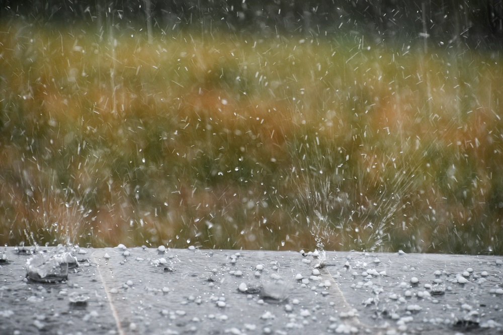 hail splashing in rain water during a hailstorm