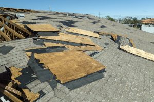 Natural disaster and its consequences. Hurricane Ian destroyed house roof in Florida residential area.
