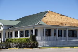 Natural disaster and its consequences. Hurricane Ian destroyed house roof in Florida residential area.