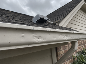 Damaged roof features and siding details