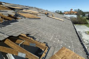  Damaged house roof with missing shingles