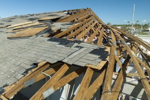 Damaged house roof with missing shingles