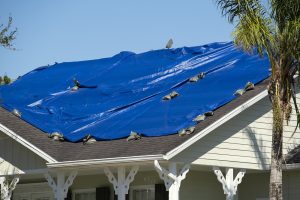 roof covered with blue protective tarp 