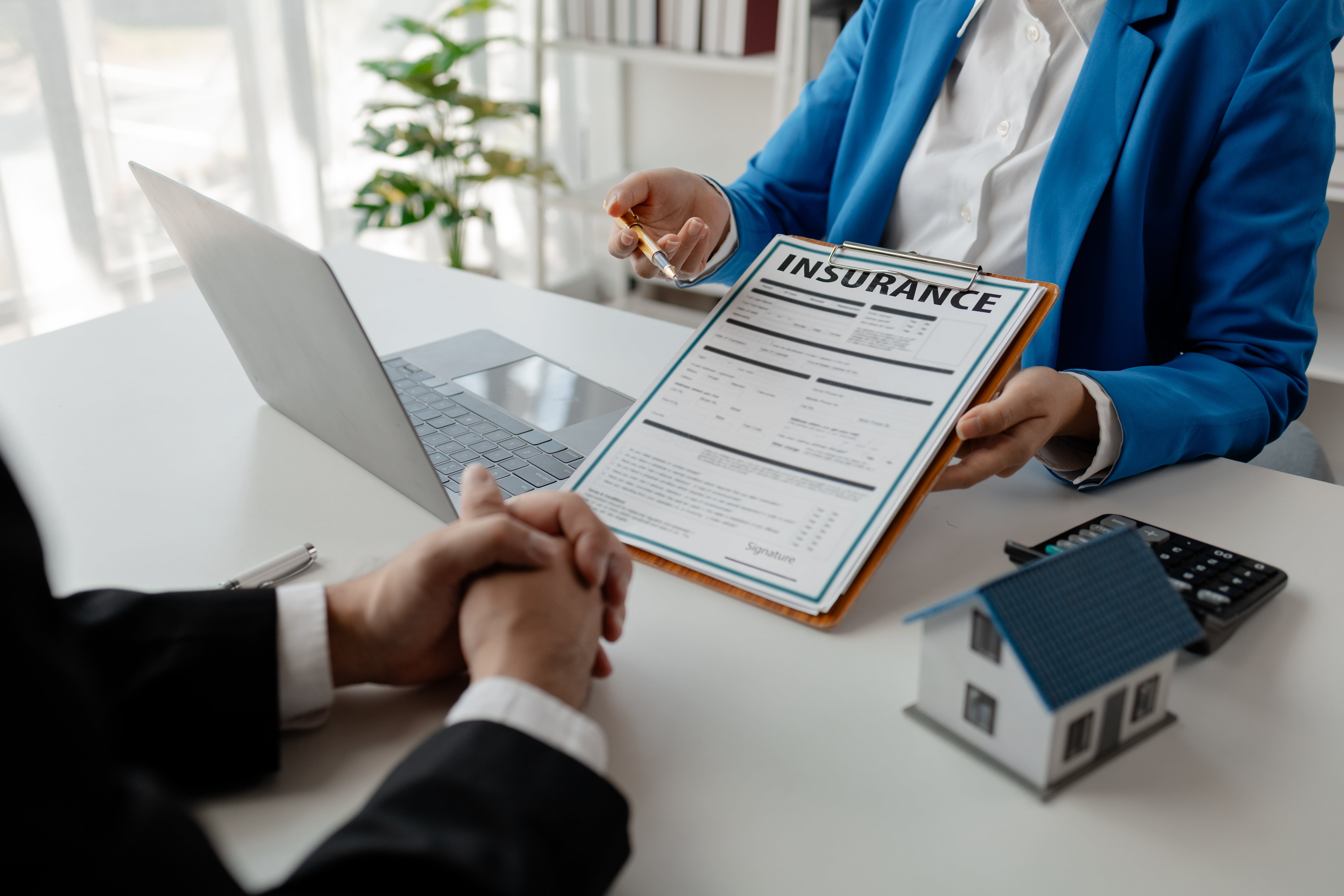 Reviewing insurance policy documents to understand roof damage claim responsibilities
