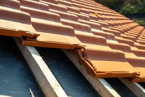 Overlapping rows of yellow ceramic roofing tiles